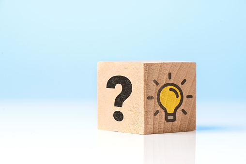 Light bulb and question mark  icons on wooden cube. Problem and solution concept.