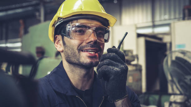 istock Factory worker talking on portable radio while inspecting machinery parts 1282970468