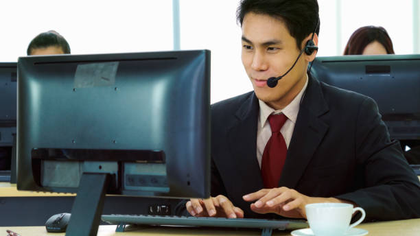 istock Business people wearing headset working in office 1282971283