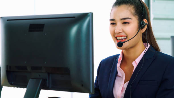 istock Business people wearing headset working in office 1282971540