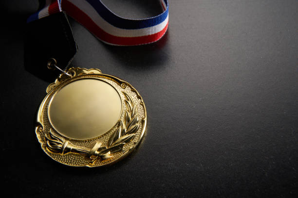 istock golden medal on green background 1282974600