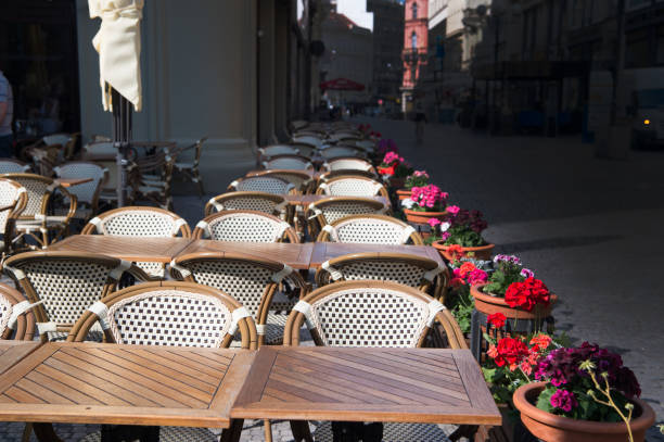 istock Tables, chairs and flowers in pots in sidewalk cafe 1282975318