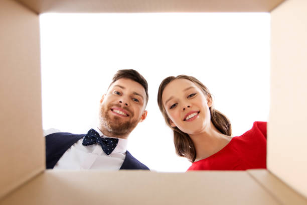 istock happy couple looking into open christmas gift box 1282975544