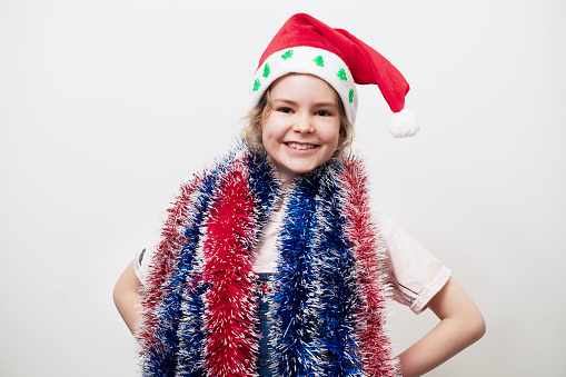 Young girl wearing Santa Hat and tinsel.