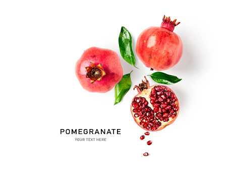 Fresh pomegranate creative layout isolated on white background. Healthy eating and dieting food concept. Winter fruits and berries composition. Top view, flat lay, design elements