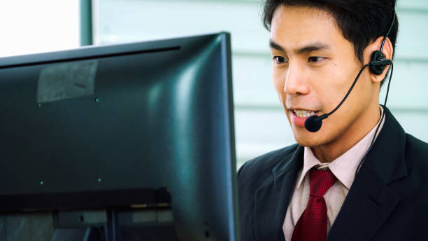 istock Business people wearing headset working in office 1282976292
