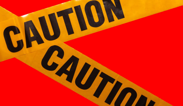 istock Yellow caution tapes crossing. Isolated. Red background. Protection against viruses, bacteria, and germs. Quarantine area. Police barrier 1282976393