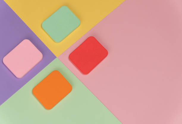 istock Top view of multi-colored sponges on different pastel-colored backgrounds. Abstract image 1282976421