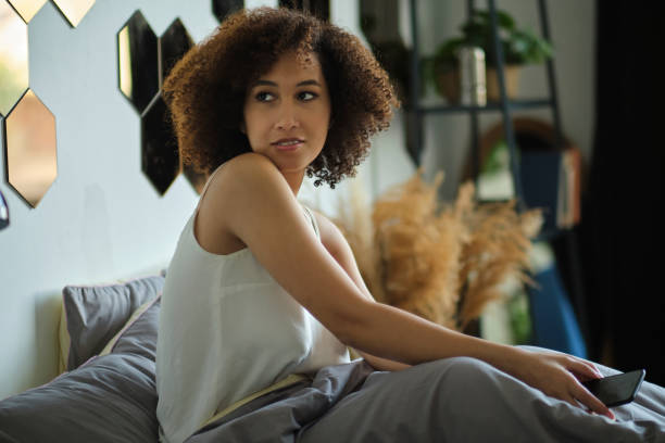 istock Smiling African American woman using mobile phone 1282977027