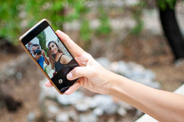 istock Woman using mobile phone outdoors 1282977947