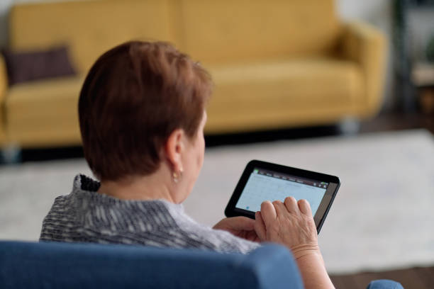 istock Senior Indian Woman Using Digital Tablet At Home 1282978796
