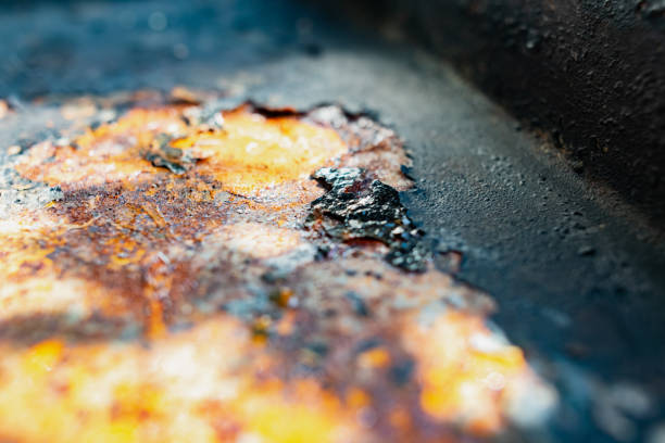 istock Very rusty surface with cracks and rough spots. Imitation of outer space in sunlight with a black coating. 1282978984