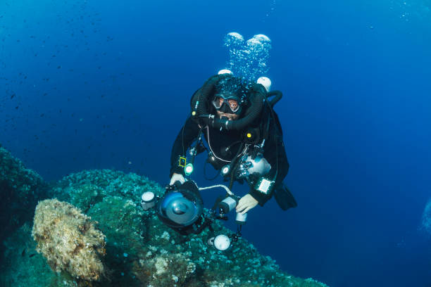 istock Underwater photographer - Technical Diving Scuba diver used Closed Circuit Rebreather Exploring and enjoying  Sea life Water sports Techdive Scuba diver point of view  deep in sea Sea life Mediterranean sea 1282978985