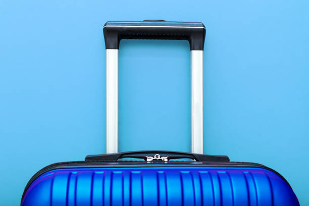 istock Modern Phantom Blue classic blue suitcase on blue background close up with copy space for text. Minimal style travel concept. Vacation trip. Summer holiday stock photo. Trendy color 2020 classic blue 1282979871