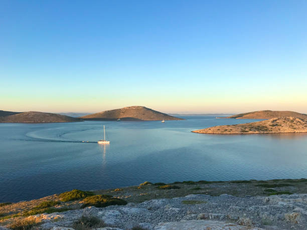 View of sailboat moving in Adriatic sea with small islands in background, Croatia.