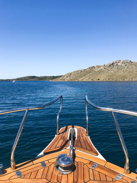 Luxury yacht moored in Adriatic sea with mountains in background, Croatia.