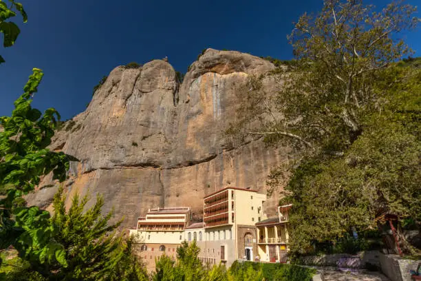 Photo of Mega Spilaio Greek Orthodox Monastery, near Kalavryta, in the Peloponnese peninsula in southern Greece. Built in a large cave in cliff where the Mount Chelmos drops down to the gorge of the Vouraikos river