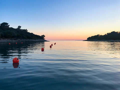 Fishing marker buoy floating in Adriatic sea at dusk, Croatia.