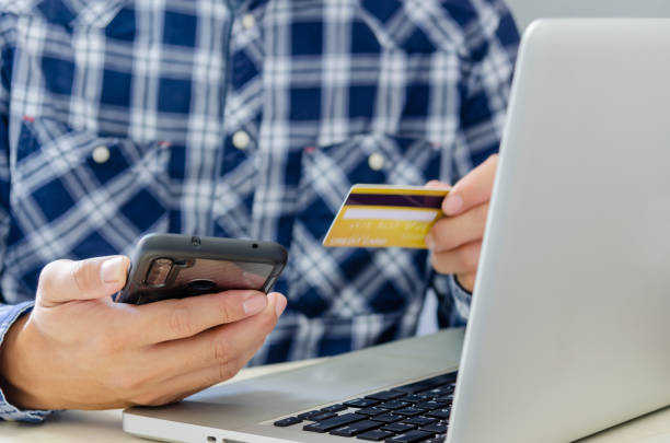 istock Man Shopping Online Using Laptop With Credit Card 1282982870
