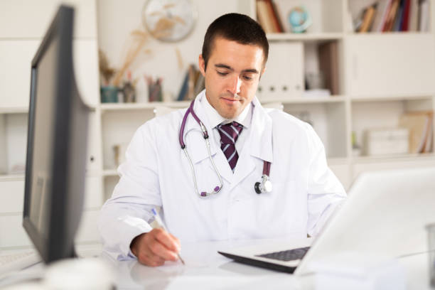 istock Focused doctor working with laptop in office 1282983306