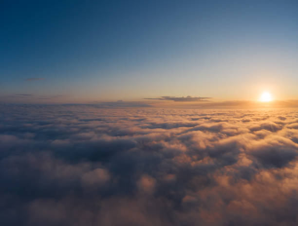 istock Beautiful sunrais cloudy sky from aerial view. Airplane view above clouds 1282983392
