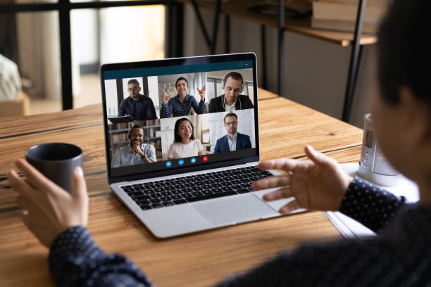 istock Back view of woman talk on video call with colleagues 1282984206