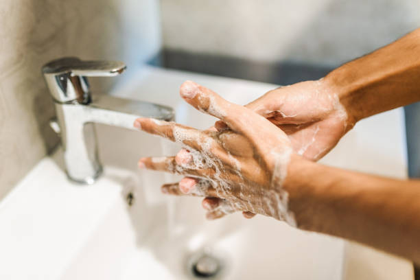 istock Unrecognizable man washing his hands with a soap. Coronavirus prevention /  hygiene concept. Things to do to stop spreading coronavirus stock photo 1282984534