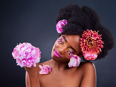 Studio shot of a beautiful young woman posing with flowers in her hair