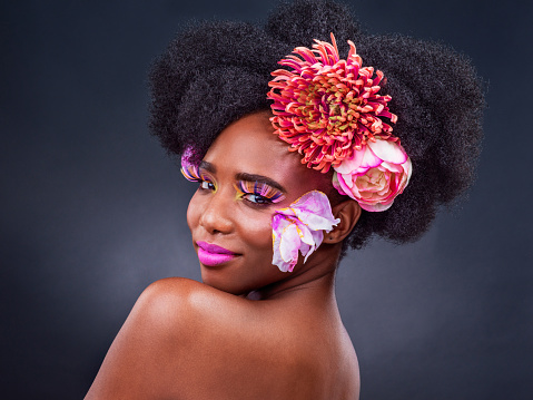Studio shot of a beautiful young woman posing with flowers in her hair