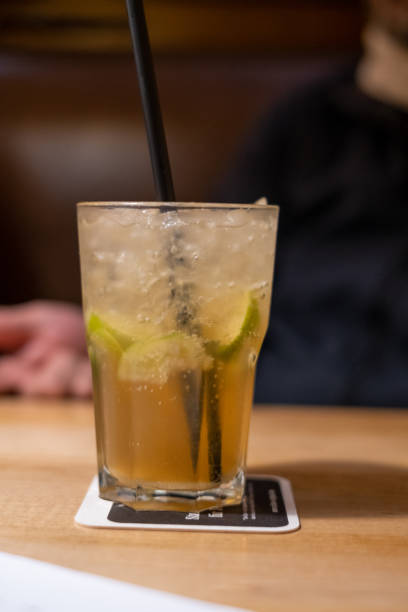 istock cocktail with straw stands on a wooden table 1282985075