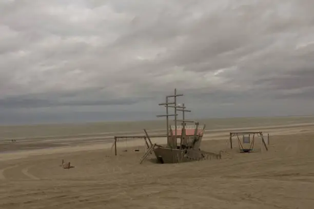 cloudy skies with deserted playground on the coastline of Belgian coastline