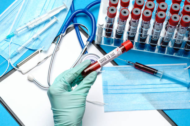 istock lab technician assistant or doctor holding a blood sample in test tube 1282986261