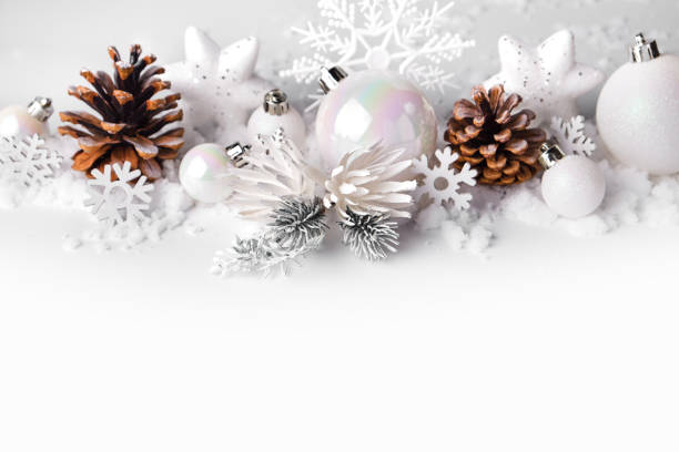 istock Silver and white Christmas balls and ornaments on white snow background 1282986667