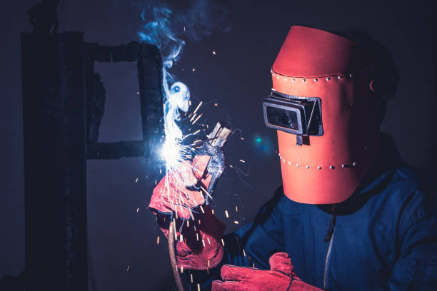 istock Metal welding steel works using electric arc welding machine 1282986695