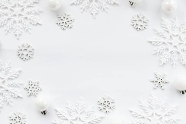 istock Pattern made of white balls and snowflakes on white background. 1282987089