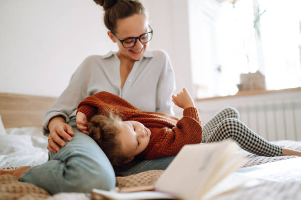 istock Young Mother playing with child during working. Mother working from home with kid. Homeschooling and freelance job. 1282987833