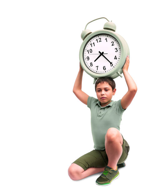 istock Schools start too early. Little boy with large alarm clock 1282987909