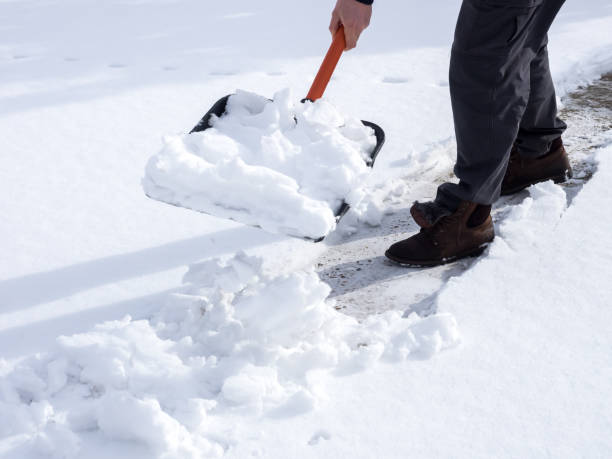 istock Close up image of worker shoveling snow from the sidewalk 1282988259