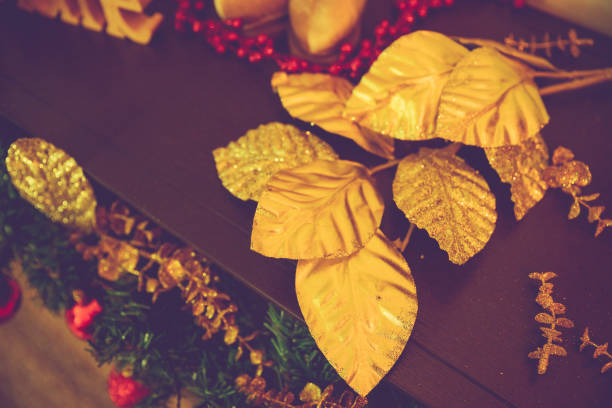 Christmas, Home Decor, Dubai - Artificial golden leaves and other decoration on the foyer table of a villa