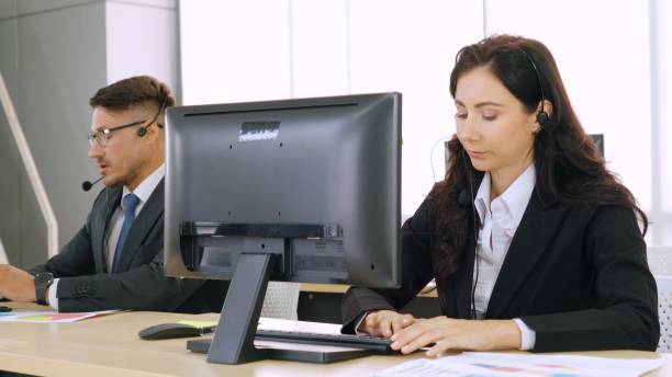 istock Business people wearing headset working in office 1282989143
