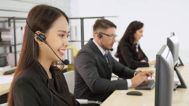 istock Business people wearing headset working in office 1282989437