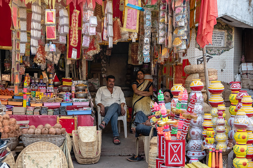 Nagpur, Maharashtra, India - March 2019: An Indian grocery store selling colorful pots, coconuts, souvenirs, religious items and other assorted products.