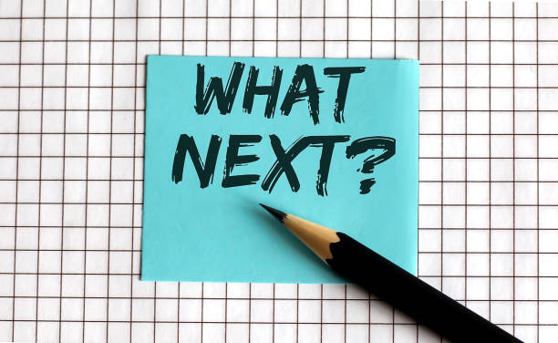 istock What next , the phrase is written on colored stickers, on a notepad background. Business concept 1282993569