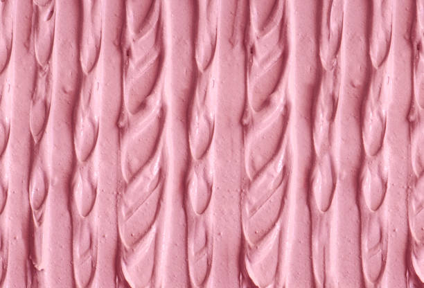 istock Pale pink cosmetic clay (alginate facial mask, face cream, body wrap) texture close up, selective focus. Abstract background with brush strokes. 1282993607
