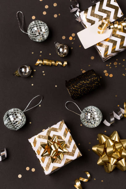 istock Christmas composition. Gold and silver decorations, mirror disco balls, gifts on  dark black background. 1282994877