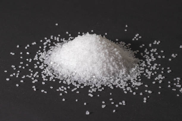 istock Heap of coarse salt on darck background 1282997936
