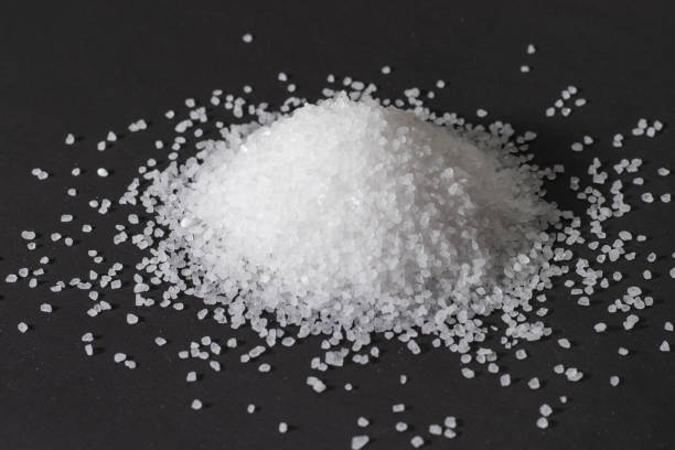 istock Heap of coarse salt on darck background 1282997943