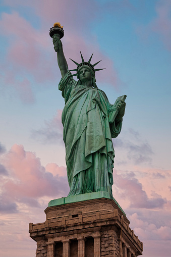 Statue of Liberty against dramatic sunset sky, Liberty Island, New York City