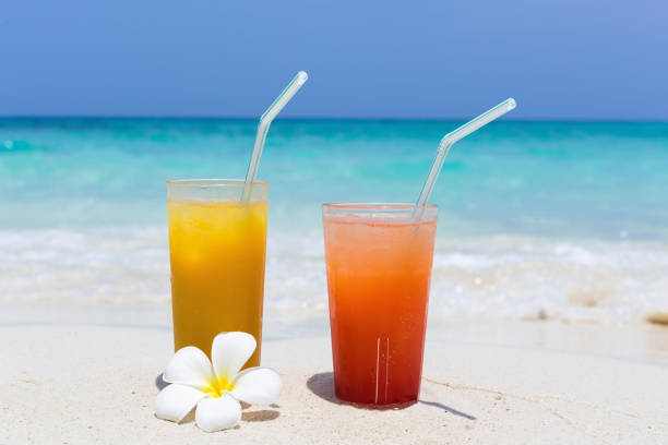 istock Cocktails in glass on white sandy beach 1283002288