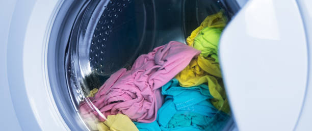 istock Process of cleaning colour cloth in washing machine, closeup 1283002888